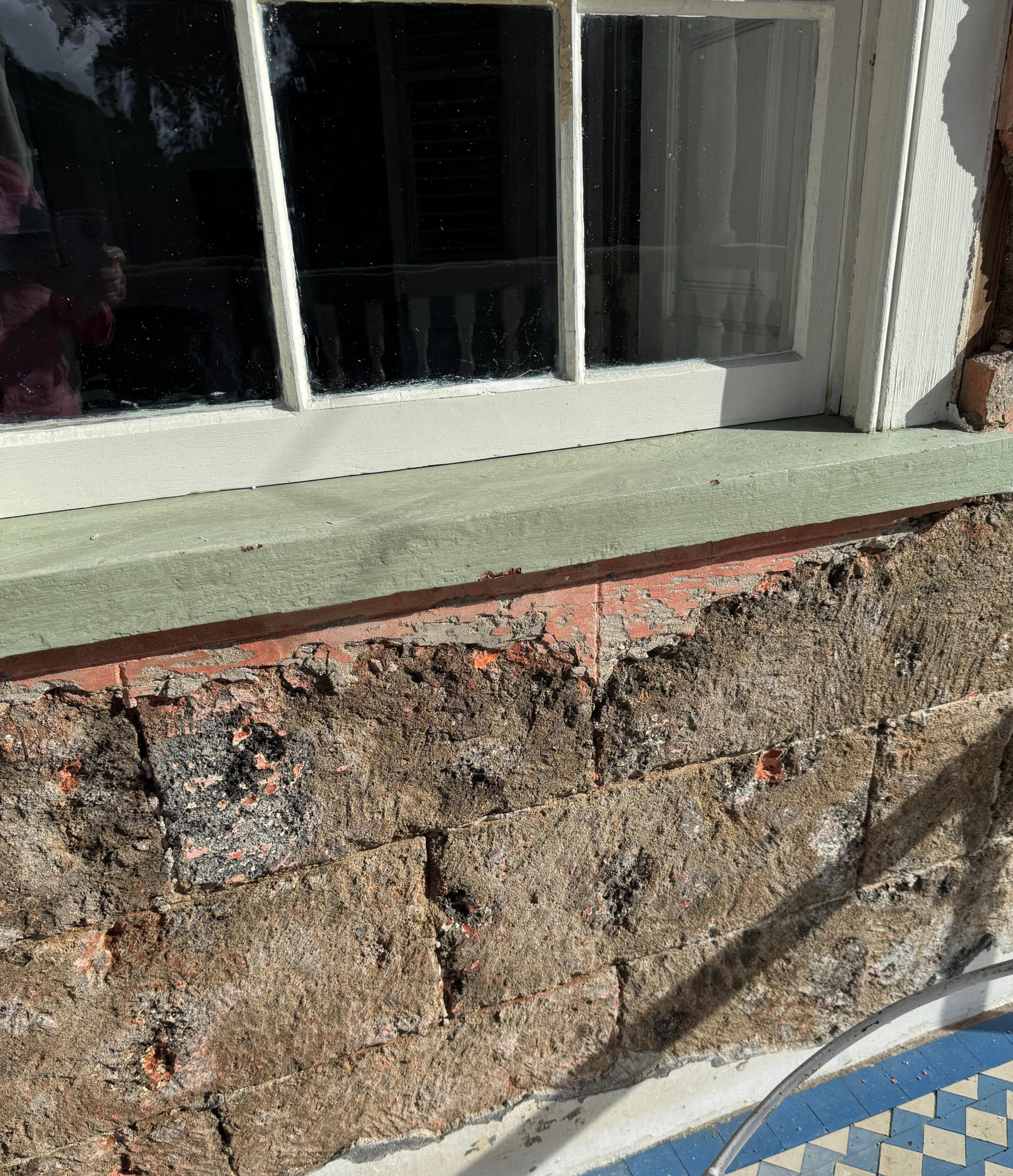 Stone work covered with red lime washed plaster, lined out to imitate Ashlar work. © 2026 Juanita Rogers. Arnos Vale House and Gardens, Casson Hill, St Vincent and the Grenadines